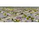 A picturesque aerial view captures a neighborhood with tree-lined streets and houses with solar panels at 5536 Kirk St, Denver, CO 80249