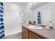 Bright bathroom boasts a shower-tub combo, sleek fixtures, and a vanity for comfort and style at 5536 Kirk St, Denver, CO 80249
