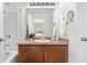 Bathroom vanity with a decorative touch, complemented by natural lighting and sleek fixtures at 5536 Kirk St, Denver, CO 80249