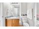 Well-lit bathroom featuring a single sink vanity, toilet and clean finishes for a modern feel at 5536 Kirk St, Denver, CO 80249