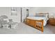 Comfortable bedroom setup with a wooden bed frame and a chair, providing a relaxing atmosphere at 5536 Kirk St, Denver, CO 80249