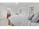 Relaxing bedroom showcases a cozy bed with plush pillows, leading to the bathroom and closet at 5536 Kirk St, Denver, CO 80249