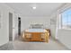 Bright bedroom featuring a wood bed frame, natural light, and an open closet, offering comfort and style at 5536 Kirk St, Denver, CO 80249