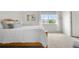 Comfortable bedroom featuring white bedding, a natural wood bed frame, and neutral carpeting at 5536 Kirk St, Denver, CO 80249