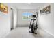 Bright exercise room with an elliptical machine and a window view for an inspiring workout space at 5536 Kirk St, Denver, CO 80249