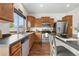 Traditional kitchen with stainless steel appliances, dark countertops, and hardwood floors at 5536 Kirk St, Denver, CO 80249