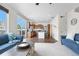 Open-concept home with a kitchen featuring wood cabinets, an island, and stainless appliances at 5536 Kirk St, Denver, CO 80249