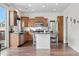 Charming kitchen with wood cabinets, stainless appliances, kitchen island and dark countertops at 5536 Kirk St, Denver, CO 80249