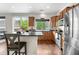 Bright, modern kitchen with stainless steel appliances and breakfast bar, perfect for entertaining at 5536 Kirk St, Denver, CO 80249