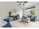 Cozy living room featuring a faux fireplace, plush seating, and a large window at 5536 Kirk St, Denver, CO 80249