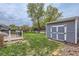 Landscaped backyard featuring a deck, storage shed, and grassy lawn, perfect for outdoor activities and storage at 10723 Cherry Ct, Thornton, CO 80233
