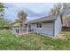 Exterior view of a house with a backyard deck, brick chimney, well-maintained lawn and tidy landscaping at 10723 Cherry Ct, Thornton, CO 80233