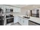 Updated kitchen with stainless steel appliances, modern countertops and white cabinets at 10723 Cherry Ct, Thornton, CO 80233