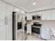 Modern kitchen with stainless steel appliances, quartz countertops and ample storage at 10723 Cherry Ct, Thornton, CO 80233
