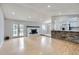 Spacious living room with fireplace, French doors, and an open bar area into the kitchen at 10723 Cherry Ct, Thornton, CO 80233