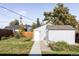 Landscaped backyard with shed and a walkway at 1531 W Dakota Ave, Denver, CO 80223