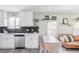 Modern kitchen with white cabinets, dark tile backsplash, and stainless steel appliances at 1531 W Dakota Ave, Denver, CO 80223