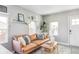 Cozy living room features a brown leather couch and a neutral color palette at 1531 W Dakota Ave, Denver, CO 80223