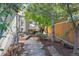 Backyard patio with mature trees and wood fence at 623 S Logan St, Denver, CO 80209