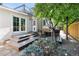 Backyard with tiered deck, seating area, mature tree and easy access to the home at 623 S Logan St, Denver, CO 80209
