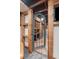 Unique basement entrance with custom shelving, decor and adjacent wet bar at 623 S Logan St, Denver, CO 80209
