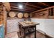 Finished basement with brick wall, bar table, and barrel accents at 623 S Logan St, Denver, CO 80209