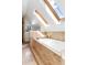 A bright, airy bathroom featuring a soaking tub with tile surround and sunny skylights at 623 S Logan St, Denver, CO 80209