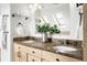 Elegant bathroom featuring dual sinks, granite countertops, and a large mirror at 623 S Logan St, Denver, CO 80209