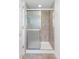 Bathroom with glass shower stall and tan tiles at 623 S Logan St, Denver, CO 80209