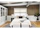 Bright bedroom featuring a cozy bed, wooden beams, and a built-in cabinet at 623 S Logan St, Denver, CO 80209