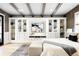 Bedroom with built-in shelves, beamed ceiling, and a comfortable bed setting at 623 S Logan St, Denver, CO 80209