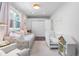 Bright Bedroom with daybed, crib, white trim, and closet with good natural light from the large window at 623 S Logan St, Denver, CO 80209