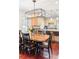 Well-lit dining room with seating for eight, and a view into the kitchen at 623 S Logan St, Denver, CO 80209