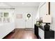 Bright foyer with hardwood floors, stylish console table, and a view into the living room at 623 S Logan St, Denver, CO 80209