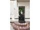 Close up of front door with brick steps, modern house numbers, and black door with window at 623 S Logan St, Denver, CO 80209