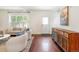 Bright living room with hardwood floors, stylish furniture, and a large window letting in natural light at 623 S Logan St, Denver, CO 80209