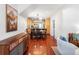 Open concept living space featuring hardwood floors, dining area, and a modern kitchen in the background at 623 S Logan St, Denver, CO 80209