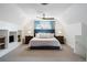 Spacious main bedroom features a stylish ceiling fan, large bed, sitting area, and excellent natural light at 623 S Logan St, Denver, CO 80209