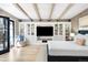 Spacious bedroom with a large entertainment center, a comfortable chair, and hardwood floors at 623 S Logan St, Denver, CO 80209