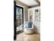 Cozy sitting area with a comfortable chair, built-in shelving, and natural light from the French doors at 623 S Logan St, Denver, CO 80209