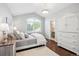 Bright bedroom with a vaulted ceiling, hardwood floors, and a view of the outside at 5672 S Nome St, Englewood, CO 80111