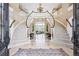 Grand foyer showcasing a dual staircase, chandelier, and elegant tile flooring at 5672 S Nome St, Englewood, CO 80111