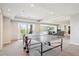 Spacious game room with a ping pong table, access to the patio, and a glimpse into the cozy living area at 5672 S Nome St, Englewood, CO 80111