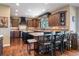 Gourmet kitchen featuring dark wood cabinets, granite countertops, and a large island with seating at 5672 S Nome St, Englewood, CO 80111