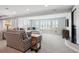 Bright living room with plush seating, shuttered windows, and a cozy fireplace, perfect for relaxation at 5672 S Nome St, Englewood, CO 80111