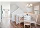 Charming dining area with a glass table, four chairs, and natural light, adjacent to the staircase at 451 Interlocken Blvd # 101, Broomfield, CO 80021