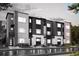 Modern townhomes with striking black and white exteriors and well-maintained landscaping at 451 Interlocken Blvd # 101, Broomfield, CO 80021