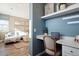 Charming home office space featuring a built-in desk, shelves, and proximity to the living area at 451 Interlocken Blvd # 101, Broomfield, CO 80021