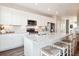 Beautiful kitchen with white cabinets, stainless steel appliances, granite countertops and a center island at 451 Interlocken Blvd # 101, Broomfield, CO 80021
