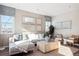 Inviting living room with modern decor, comfortable seating, and large windows with neighborhood views at 451 Interlocken Blvd # 101, Broomfield, CO 80021